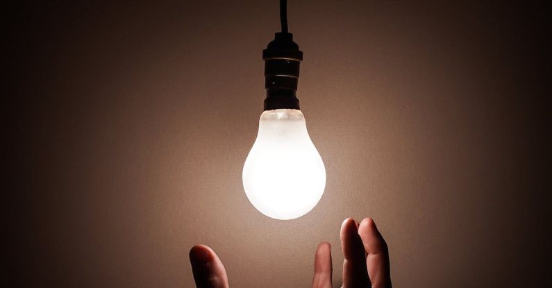 Imagery - Person Holding White Light Bulb