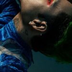 Artistic Techniques - A man with green hair and blue hair is laying down