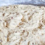 Proofing - Fresh dough with nut pieces in bowl