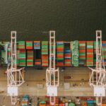 International Distribution - Colorful cargo containers on ship near pier