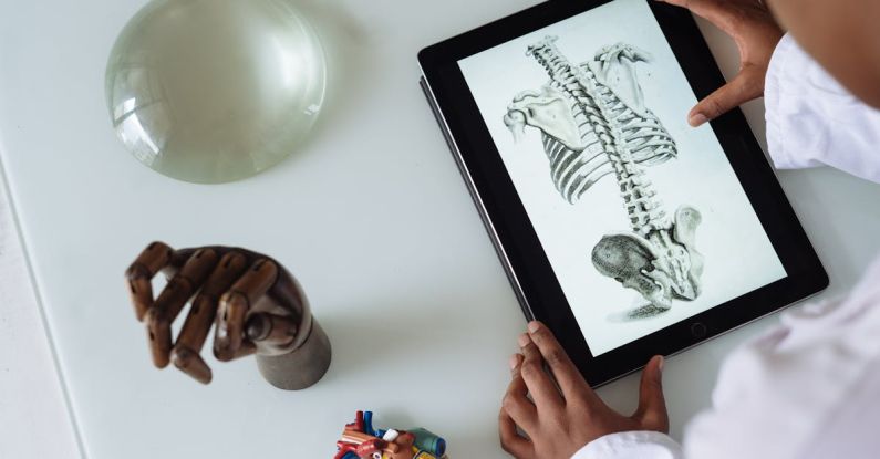 Coated Paper - Unrecognizable African American scientist studying anatomy with tablet