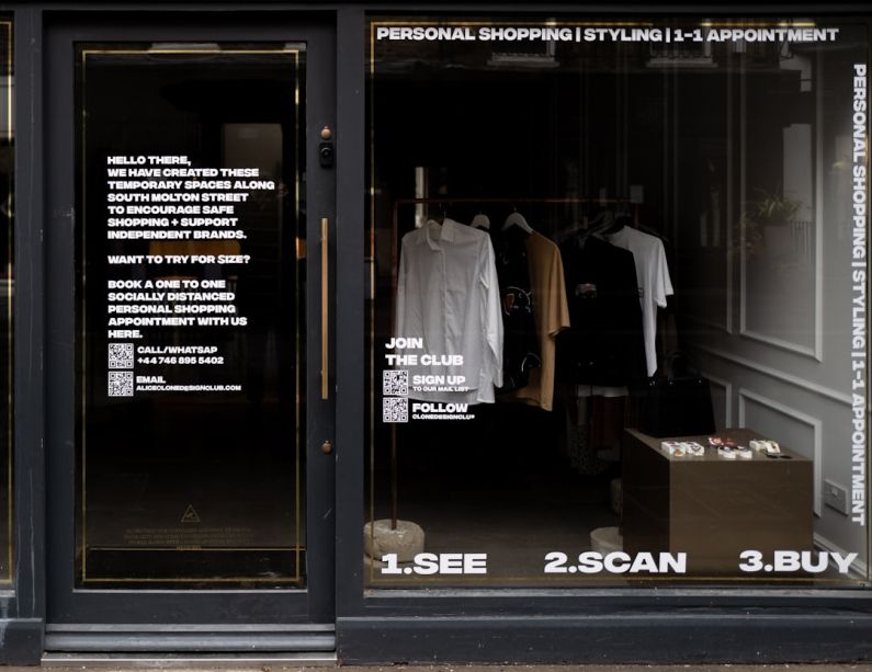 Omnichannel - white dress shirt hanging on brown wooden cabinet